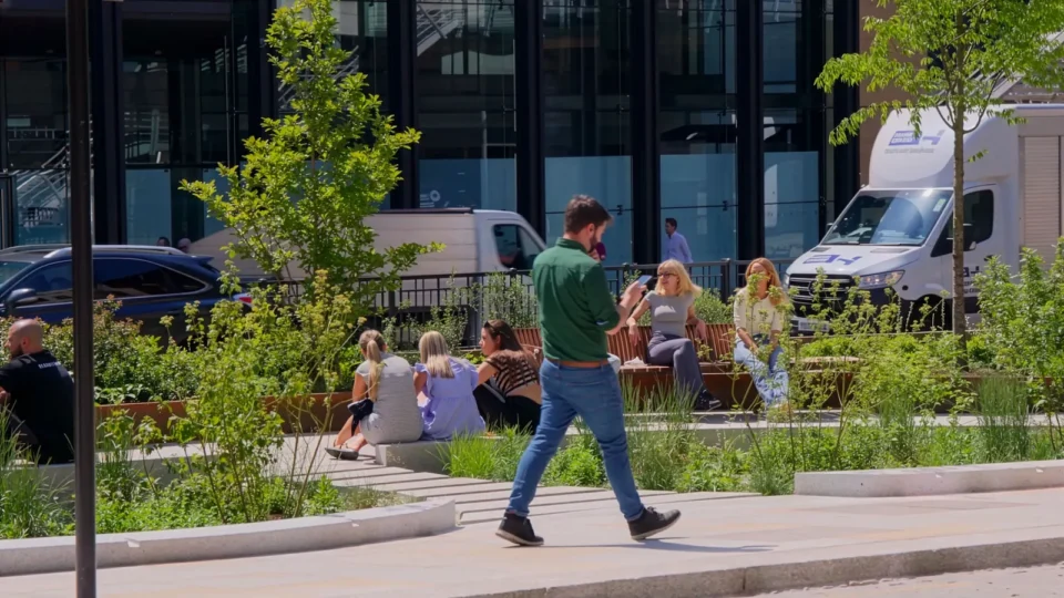 Little Trinity Lane public realm scheme in the City of London, with Corten steel planters and people relaxing among the greenery